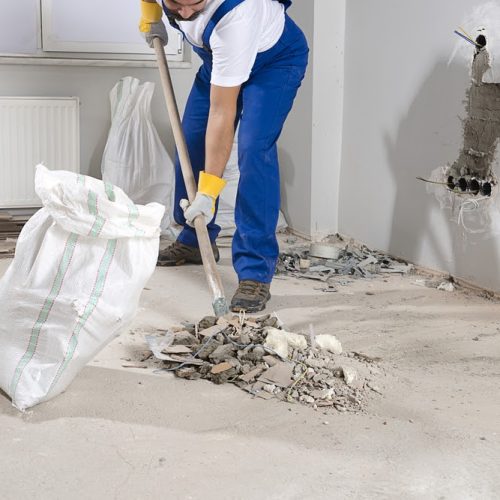 Construction Worker in Safety Clothes Shoveling